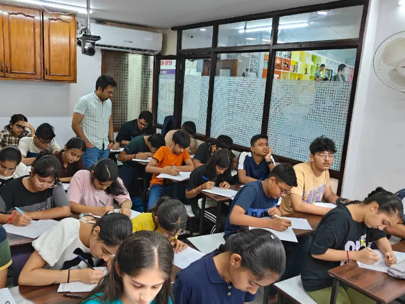 Teacher monitoring student progress and guiding individually in class